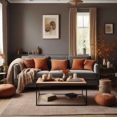 a living room with grey walls and orange pillows on the couch, coffee table in between two windows