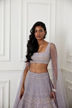 Lilac organza lehenga with glass beads, zardozi and pearl embellishments paired with raw silk embroidered blouse with long tulle cape sleeve.From Chamee and Palak's The Romantics collection.DELIVERY TIMEPlease allow 8-12 weeks for your outfit to arrive.FABRIC DETAILSOrganza, Silk, NetProfessional cleaning only. Designer Silk Sharara With Cape Sleeves, Designer Sharara With Silk And Cape Sleeves, Festive Chanderi Lehenga With Cape Sleeves, Fitted Anarkali Set With Cape Sleeves For Reception, Organza Lehenga With Dupatta And Cape Sleeves, Festive Organza Lehenga With Cape Sleeves, Fitted Lehenga With Resham Embroidery And Cape Sleeves, Bollywood Palazzo Set With Dupatta And Cape Sleeves, Fitted Choli With Resham Embroidery And Cape Sleeves