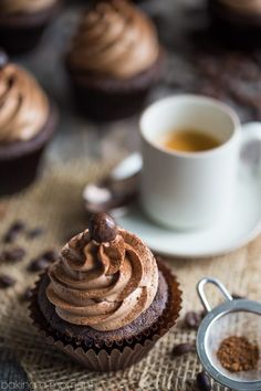 cupcakes with chocolate frosting and coffee on the side