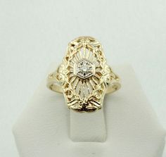 "Elegant Edwardian vintage 14K yellow gold filigree ring set with a diamond. This ring is in excellent condition and is marked \"14K\". A wonderful addition to your personal jewelry collection. FREE SHIPPING! Details: 14K Yellow Gold: (as shown in picture) Natural Diamond: (1) 3 mm round Approximate Total Diamond Weight: 0.11 carats Diamond Clarity: SI Diamond Color: G Ring Size: 6 1/4 Approximate Top Dimensions: 3/4 inch x 1/2 inch Total Weight: 2.9 grams FREE Domestic Shipping by USPS Priority Vintage 14k Gold Diamond Ring With Filigree, Vintage 14k Gold Filigree Diamond Ring, Antique 14k Gold Diamond Ring With Filigree, Vintage 14k Gold Filigree Ring With Diamond Accents, Antique Filigree 14k Gold Diamond Ring, Antique Yellow Gold Diamond Ring With Filigree, 14k Gold Vintage Filigree Ring, Vintage Filigree Ring In Yellow Gold For Anniversary, Vintage Gold Filigree Ring With Diamond Accents