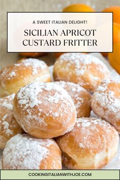 a pile of sugared apricot custard fritters with oranges in the background