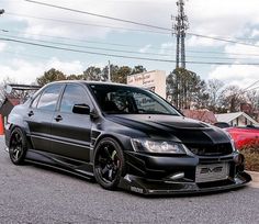 the black car is parked on the side of the road