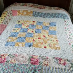 a bed with a quilt on top of it