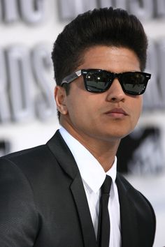 a man wearing sunglasses and a suit