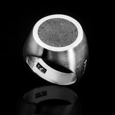 Sterling silver round "ADAMAS" urban ring. Weight: 14 gr. Sizes: 55-66 EU / 7-11.5 US Product Description:  Make a bold statement with this handcrafted men's sterling silver ring, featuring an eye-catching volcanic lava stone inlay. This unique signet ring combines the raw beauty of natural lava stone with the sleek elegance of sterling silver, creating a piece that is both rugged and refined. The smooth, brushed silver band contrasts beautifully with the textured, dark lava stone, making it a s Modernist Oval Sterling Silver Ring, Modern Handmade Oval Signet Ring, Handmade Modern Oval Signet Ring, Modern Hallmarked Round Signet Ring, Modernist Oval Rings With Polished Finish, Modernist Dome Ring With Polished Finish, Polished Modernist Dome Ring, Modernist Polished Signet Ring, Modern Silver Engraved Dome Ring