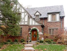 a brick house with a wreath on the front door