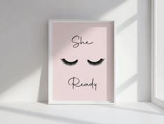 a pink poster with eyelashes and the words she's ready