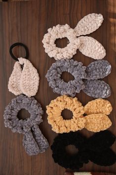 crocheted hair accessories laid out on a wooden surface