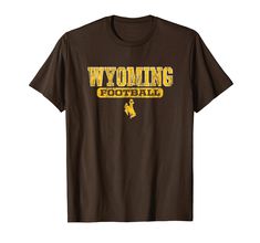 PRICES MAY VARY. Fan favorite Wyoming Cowboys men's apparel short sleeve shirt that is a great addition to any Wyoming fans wardrobe, making it a perfect gift for Christmas or graduation This Wyoming men's short sleeve shirt has a high quality digitally printed graphic perfect for any Cowboys fan that loves the classic design. Each shirt is officially licensed by University of Wyoming Lightweight, Classic fit, Double-needle sleeve and bottom hem Bar Shirts, Cowboys Apparel, University Of Wyoming, Wyoming Cowboys, Cowboys Men, Cowboy Outfits, Boxing T Shirts, Mens Short Sleeve Shirt, Men's Apparel