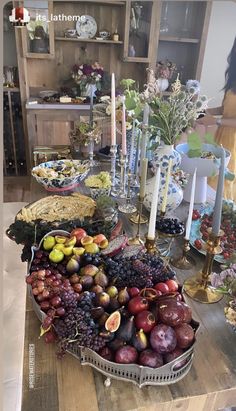 a wooden table topped with lots of different types of fruits and vegtables