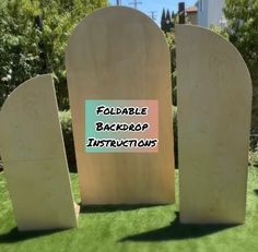 two cement tombstones with the words foldable backdrop instructions on them in front of some trees