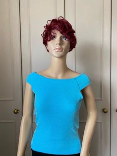 A beautiful knitted sleeveless top in a frosty sky blue colour. It can be worn on or off the shoulder.  This top is fully lined, and medium weight and ideal for holding shape. A very glamorous looking top which looks good with dance trousers and will dress up plain trousers, jeans or leggings Measurements  One only available in small to medium size Bust 80-104cm Waist 66-96 Hips 76-106cm Length 52cm This garment can fit more than one size. If you have the smaller measurements this will be a loos Fitted Sleeveless Crop Top For Evening, Blue Off-shoulder Party Blouse, Stretch Knit Evening Top, Stretch Knit Top For Evening, Evening Stretch Knit Top, Off-shoulder Stretch Tank Top For Party, Stretchy Off-shoulder Tank Top For Party, Stretch Off-shoulder Tank Top For Party, Fitted Knit Top For Evening