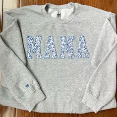 The perfect personalized gift for all of the moms in your life . . . . . . . . . . . . . . . . . Cozy sweatshirt with "Mama" hand sewn in place with fabric of your choice (see last photo). If you would like a different fabric, please message with specifications of what you are interested in. Option for embroidery of up to four letters on the right sleeve. Letters will be in white, separated by a heart in a color that correlates with the fabric chosen for the appliqué. Customizable Casual Fleece Sweatshirt, Personalized Cotton Crew Neck Sweatshirt, Personalized Cotton Sweatshirt For Winter, Personalized Long Sleeve Sweatshirt, Personalized Cotton Sweater For Winter, Personalized Tops As Fall Gifts, Customizable Cotton Sweatshirt For Loungewear, Personalized Cotton Sweatshirt With Name Print, Customizable Family Matching Cotton Sweatshirt