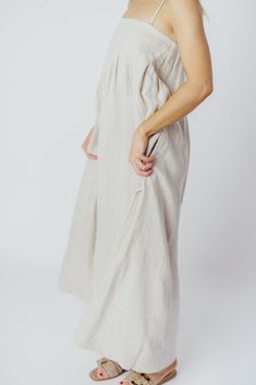 Expertly crafted from premium-quality linen, the Zabina Maxi Dress offers a stylish and comfortable option for all your warm-weather activities. This gem is lightweight, ultra-comfortable, and thanks to its removable straps, a beautifully versatile addition to your wardrobe. FIT: Runs true to size - relaxed fit. MATERIAL: 100% Linen. GARMENT DETAILS: Relaxed maxi dress in 100% linen, with removable spaghetti straps. Features dual in-seam pockets, with a back button closure and gently-defined empire waist. SIZE GUIDE: S (2-4) / M (6-8) / L (10-12) MODEL DETAILS: Heather is wearing size S. Mackenzie - Size S Heather - Size S Molly - Size XL Our Brunette Misses Model Our Blonde Misses Model Our Blonde Curve Model Bust 34" 34" 37" Waist 27.5" 27.5" 32" Hips 40.5" 37.5" 47" Height 5'7" 5'7" 5'7 Neutral Linen Summer Dress, Unlined Linen Dress For Daywear, Daywear Linen Dress With Slip Pockets, Linen Dress With Slip Pockets For Daywear, Relaxed Fit Flax Linen Dress, Neutral Linen Dress For Beach, Neutral Linen Dress For The Beach, Neutral Linen Dress For Vacation, Beige Linen Dress For Vacation