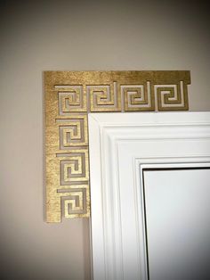 a white door with some gold designs on the front and back of it's frame