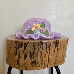 a crocheted hat sitting on top of a wooden table