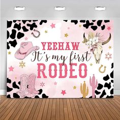 a pink and black cow print wall hanging on the side of a room with wooden floors