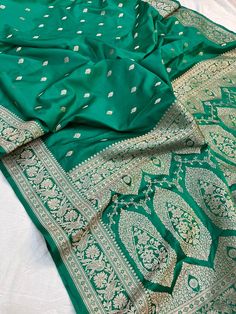 This is a very beautiful high quality mashru silk saree . All over zari motifs design with border . Saree length - 5.5 mtr. Blouse - 1 mtr. Dry clean only . Please note - color may be vary a little due to sunlight and photography . Please message us after purchasing in case you want fall and Pico done it not . No extra charges for fall and Pico but inform us . Blouse stitching is also available . Elegant Green Saree For Puja, Elegant Green Dola Silk Saree, Elegant Green Katan Silk Saree, Elegant Designer Unstitched Suit With Zari Weaving, Elegant Unstitched Suit With Zari Weaving For Designer Wear, Green Dola Silk Saree With Motifs, Designer Green Saree With Motifs, Elegant Saree With Motifs For Eid, Green Katan Silk Lehenga