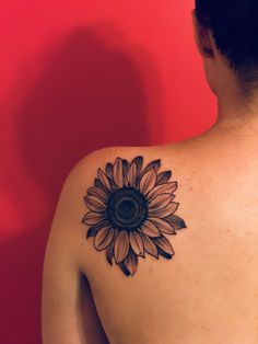 a woman with a sunflower tattoo on her back