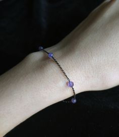 Moonglow. Βeauty and magic in the most delicately dark way. This bracelet is composed of black rhodium over 925 sterling silver delicate sparkling chain, 4mm purple amethyst gemstones. You can choose between these chain lengths: 15 / 16 / 17 / 18 inches Not sure which length to buy? We can add a 1 inch extender chain. Just write a note at checkout! ❈ We send all our items with registered mail. ❉ Due to the organic nature of stones, there might be a slight variation in colour, size and shape. ✺ All items come packaged in a quality velvet pouch ready for gift giving. ✽ If you want to make a special order, just contact us! Handmade Minimalist Purple Bracelets, Minimalist Handmade Purple Bracelets, Handmade Minimalist Purple Bracelet, Purple Minimalist Handmade Bracelet, 90s Jewelry, Gothic Bracelet, Organic Nature, Purple Gems, Black Bracelet