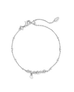 The Mama Script Delicate Chain Bracelet in Silver is as stylish as it is meaningful. Designed in a gorgeous script and embellished with a dainty cultured freshwater pearl, this gift-worthy bracelet will add meaning to her wrist stack. Plus, it has an adjustable closure for a perfect fit. Metal Rhodium Over Brass Material White Pearl Closure Lobster Clasp W/ Single Adjustable Slider Bead Size 8" Chain With .17"L X .94"W Pendant Material Highlight: White Pearl Inspiring peace, tranquility, and healing, each cultured pearl is grown in a freshwater pearl mussel, is one-of-a-kind, and can take up to four years to produce.Due to the one-of-a-kind nature of the medium, exact colors and patterns may vary slightly from the image shown. | Kendra Scott Mama Script Delicate Chain Bracelet in Silver | Wrist Stacks, Bracelet In Silver, Script Writing, Kendra Scott Necklace, Simple Bracelets, Delicate Chain, Pearl Charms, Chain Choker, Brass Material