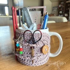 a cup with some items in it sitting on a table