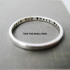 "This too shall pass is stamped inside this stackable, solid sterling, personalized ring.   Perhaps a good gift idea for a friend/family member going through a difficult time - or even yourself.  The words can be stamped inside (as shown) or outside the ring.  You can add initials or a date or perhaps a tiny heart outside.  It's up to you.   Life can be hard sometimes.   Wearing some inspiration close to your skin can help.  Want more than one? Here is the link to the money saving sets listing: This Too Shall Pass Quote, Stamped Ring, Thick Ring, This Too Shall Pass, Stamped Rings, Personalized Ring, Ring Stacking, Tiny Heart, Personalized Rings