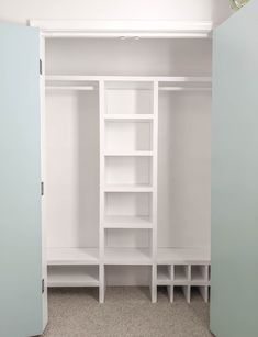 an empty white closet with shelves and cupboards