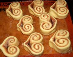 several cinnamon rolls on a baking sheet ready to go into the oven or bake