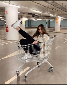 a woman is sitting in a shopping cart