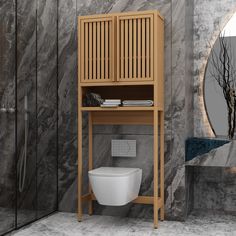 a bathroom with marble walls and flooring, including a wooden cabinet over the toilet