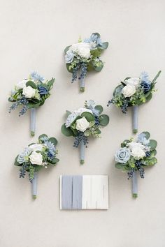 wedding bouquets and boutions laid out on the wall in front of each other