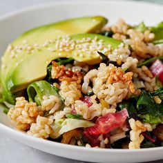 a white bowl filled with rice and vegetables