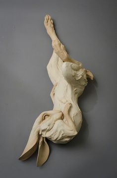 a sculpture of a woman laying on her back