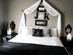 a black and white bedroom with candles on the nightstands