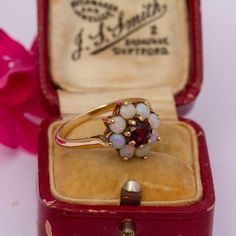 Size: N 1/2 (UK/Aus), 6 3/4 (US/Can), 54 3/4 (Eur) The gemstones in the jewellery are all natural stones. We do not sell jewellery containing manmade, synthetic or laboratory grown stones. This beautiful 1934 9ct yellow gold opal and garnet halo cluster daisy ring features eight stunning fiery round cut opals, all of which display the full spectrum of hues surrounding a sparkling central deep red round cut garnet of approx. 5mm diameter. The ring is in overall excellent condition (Please see con Daisy Ring, Full Spectrum, Selling Jewelry, Cluster Ring, Deep Red, Rings Statement, All Natural, Round Cut, Favorite Jewelry