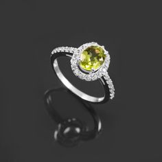 Green Oval Sapphire Promise Ring, Green Oval Sapphire Ring With Center Stone, Oval Green Sapphire Ring With Halo Setting, Green Halo Promise Ring, Elegant Lime Green Oval Rings, Green Oval Birthstone Ring With Halo Setting, Lime Green Promise Ring With Birthstone, Lime Green Peridot Rings For Promise, Lime Green Diamond Gemstone Rings