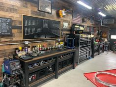 a garage filled with lots of tools and other things on the wall, including shelves