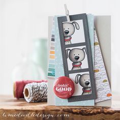 a close up of a card on a wooden table with yarn and scissors in the background