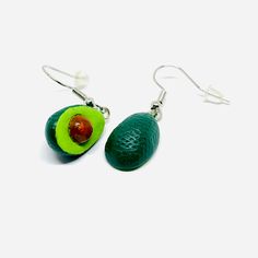 Inspired by the vibrant culture and art of Mexico, these Avocado Clay Earrings are a must-have for any fashion-forward individual. Hand-crafted by skilled artisans, each intricate design showcases the beauty of traditional Mexican jewels. Indulge in the delicious combination of mini realistic drops and dangle earrings that radiate natural charm and elegance. Perfect for summer fashion, these earrings are a unique and memorable gift that will be cherished and worn with pride. Gift-ready, these ea Mexican Avocado, Handmade Clay Jewelry, Mexican Jewelry, White Clay, Brass Metal, Memorable Gifts, Showcase Design, Clay Jewelry, Clay Earrings