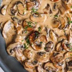 a skillet filled with mushrooms covered in gravy