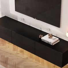 a flat screen tv mounted to the side of a wall next to a wooden floor