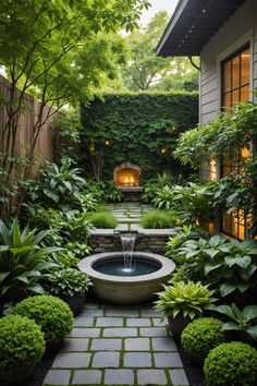 an outdoor garden with a fountain surrounded by greenery