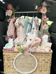 a wicker basket filled with baby items in the back seat of a car,