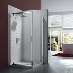 a white bath tub sitting next to a shower in a bathroom with red walls and flooring