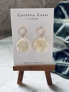 100% Handmade white jingle shells are arranged as beautiful drop earrings. They are very lightweight , great for all day wear. These nickel-free earrings feature gold-plated circle stud findings for comfort and simple aesthetic .  The shells for each pair are hand picked, and are meticulously assembled. These earrings have an organic and minimal look while still being very versatile. Would even make a beautiful addition to a beach bridal look. Please note,  each shell and by extension each pair have its own characteristics making them beautifully one of a kind . Cream Shell Jewelry For Gifts, Cream Shell Jewelry For Gift, Adjustable White Mother Of Pearl Earrings, Bohemian White Mother Of Pearl Earrings, White Shell Dangle Jewelry, White Shell Earrings With Pearl Drop, White Shell-shaped Pearl Drop Earrings, White Shell Shaped Pearl Drop Earrings, White Pearl Drop Shell-shaped Earrings