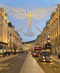 a street with cars, buses and christmas lights