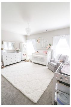 a baby's nursery room with white furniture and pink accessories on the rugs