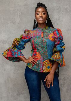 Our Amari long sleeve mandarin collar shirt in New Harvest Multipattern print is perfect for a refined aesthetic. The shirt's puff sleeves elevate the style with a feminine touch. The top may be dressed up with slacks and heels for the office, or down with a pair of black jeans and flats for a more laid-back vibe. Ankara Top Styles, African Print Top, Modern African Clothing, Ankara Blouse, African Blouses, Ankara Tops, African Tops, African Print Tops, Mandarin Collar Shirt