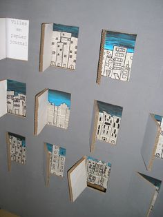 several pieces of cut out paper are hanging on the wall